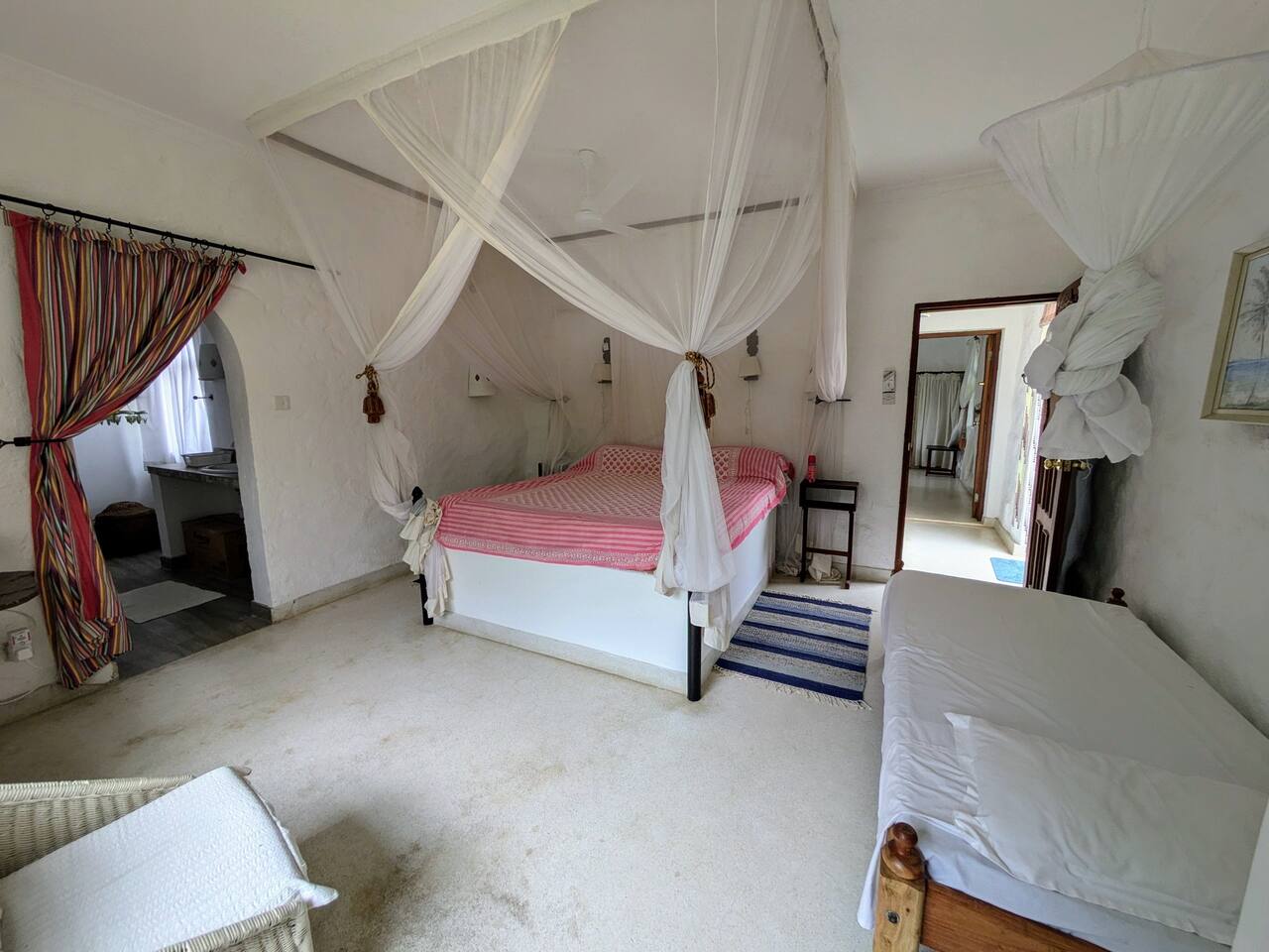 En-suite bedroom with double bed and mosquito net at Marijani Villa Marijani villa bed