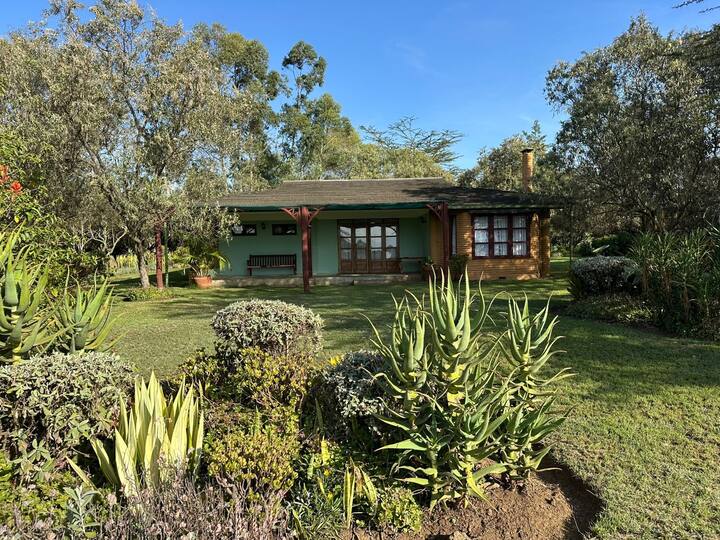 Manicured gardens with Leleshwa vegetation at Kedong Cottage Kedong Cottage garden